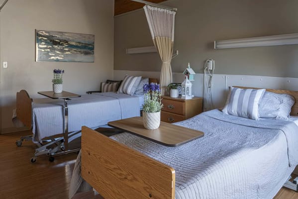 A well-furnished resident room with two beds