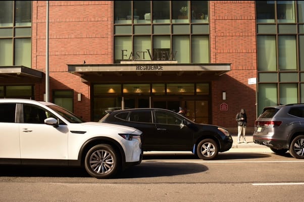 Exterior view of Eastview Residence with parked cars