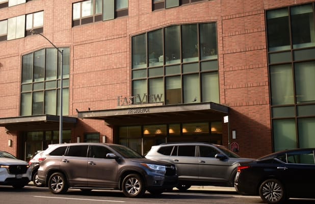 Exterior view of Eastview facility entrance with vehicles parked