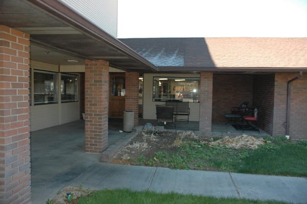 View of the entrance with brick pillars and seating area
