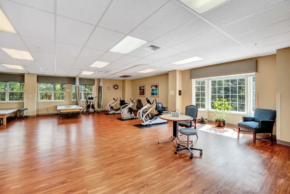 Bright fitness area with exercise equipment and natural light