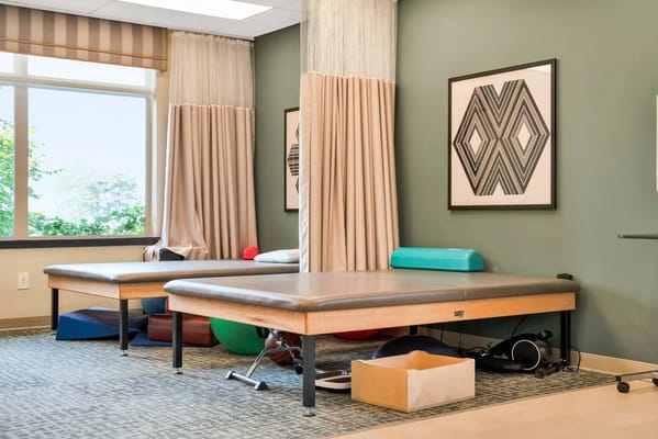 Therapy room with treatment tables and exercise equipment