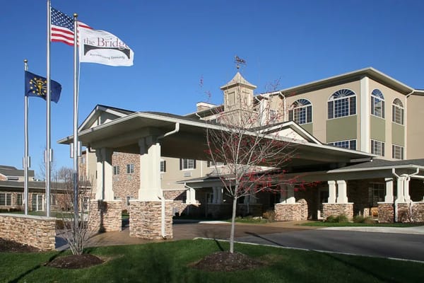 Front entrance of the assisted living facility with flags