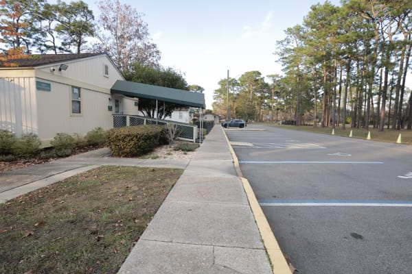 Entrance to Cecil Pines Adult Living Community surrounded by trees