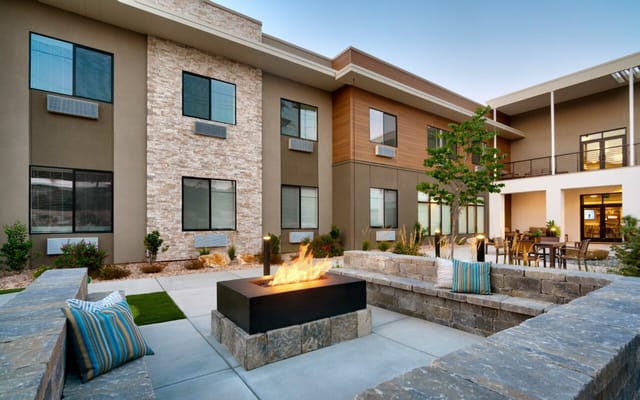 Outdoor seating area with fire pit and landscaping