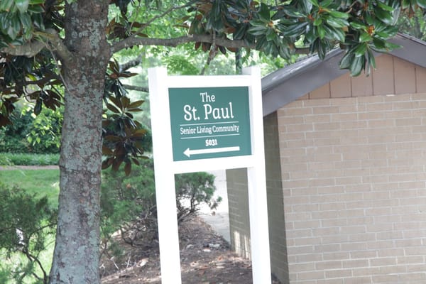 Sign for The St. Paul Senior Living Community with directional arrow