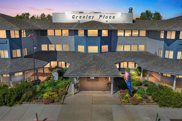 Exterior view of Greeley Place with landscaped entrance