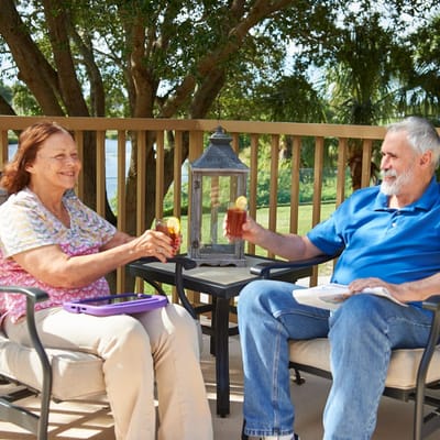 Two residents enjoying drinks on a patio