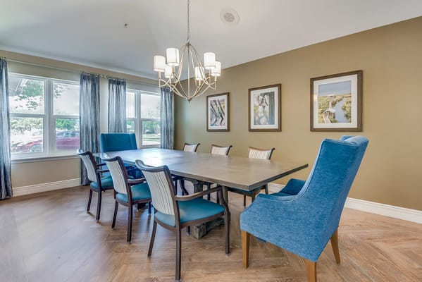 Stylish dining area with a large table and blue chairs