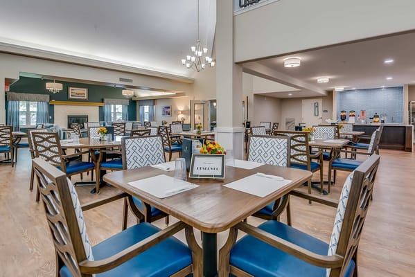 Dining area with tables and chairs set for meals