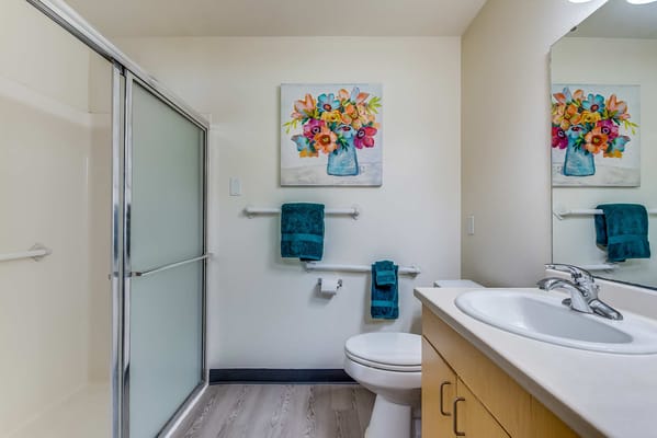 Well-lit bathroom with floral decor and modern fixtures