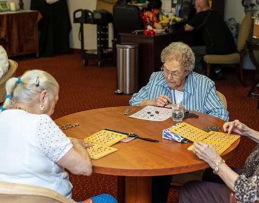 Residents playing bingo at a communal table