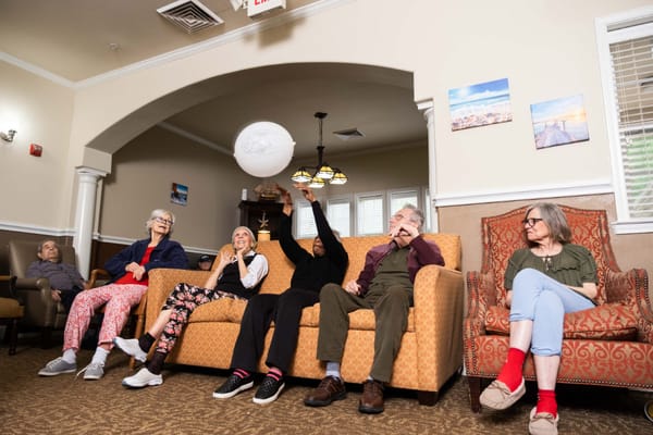 Residents enjoying an indoor activity in a cozy lounge