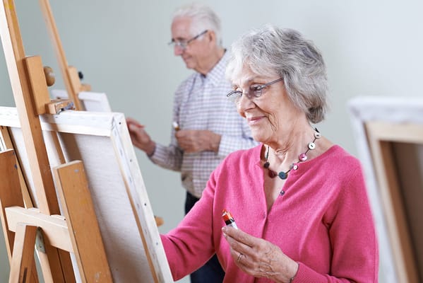 Residents painting in an activity room