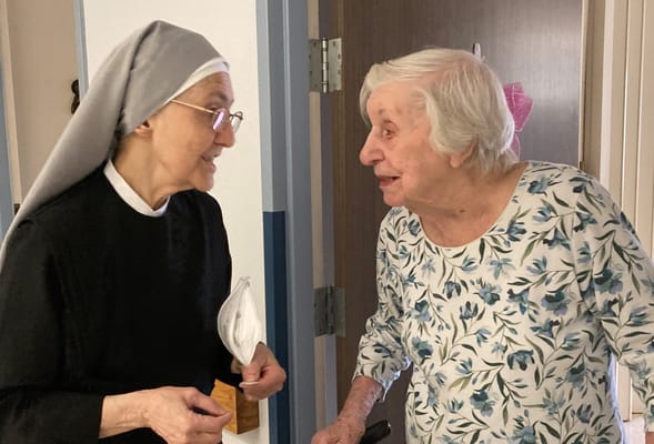 A staff member and resident engaging in conversation