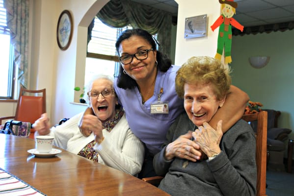 Care staff interacting with residents at a table