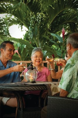 Residents enjoying drinks in a lush outdoor setting