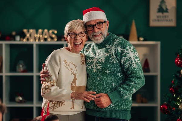 Two residents celebrating Christmas in festive sweaters
