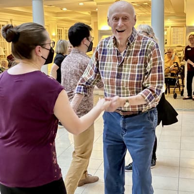 Residents and staff dancing in the common area