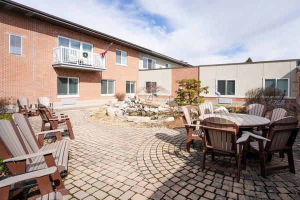 Outdoor seating area with paved walkway and landscaping