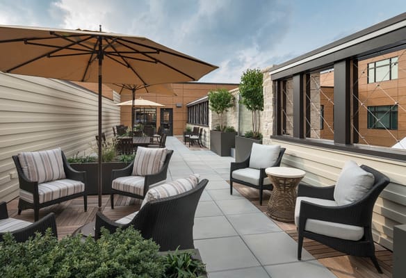 Outdoor patio area with seating and umbrellas