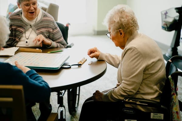 Residents playing Scrabble in an activity room