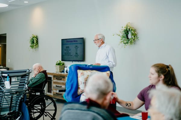 Residents engaging in an activity led by staff member