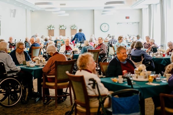 Residents dining in a cheerful common area