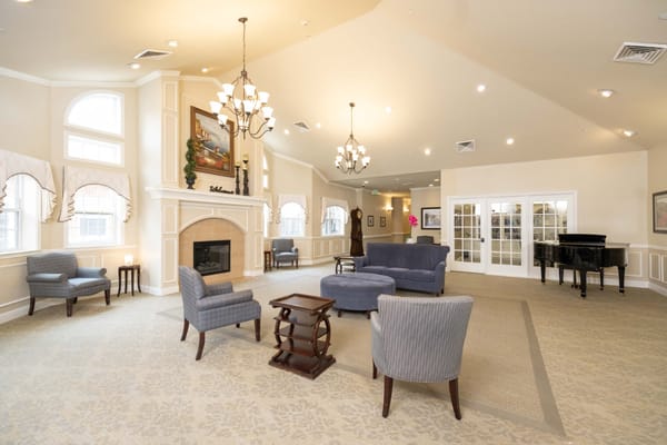 Bright common area with seating and piano