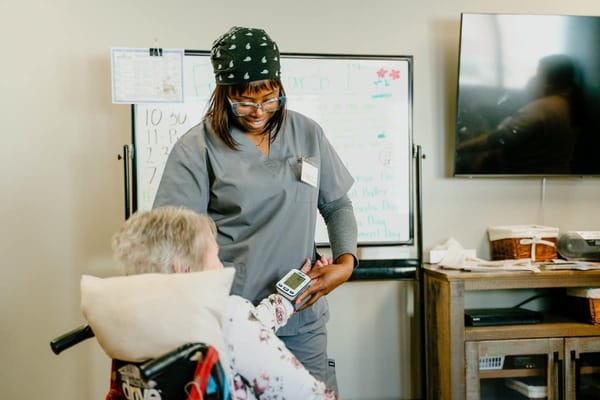 Nurse assisting a resident at a care facility