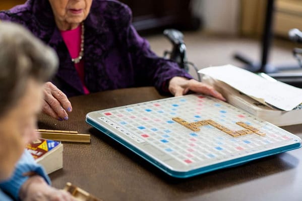 Residents playing Scrabble in a common area