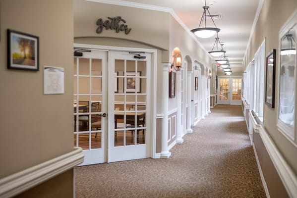 Indoor hallway leading to a gathering space