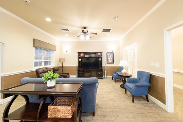 Bright common area with chairs and television