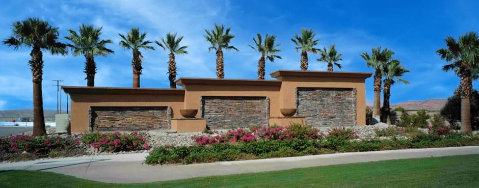 Entrance view with palm trees and landscaping