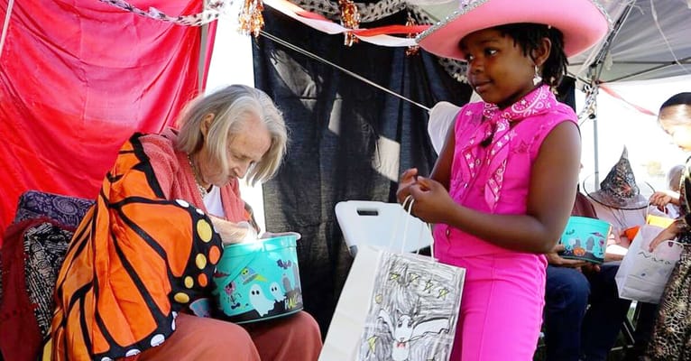 Residents engaging in an outdoor Halloween-themed activity
