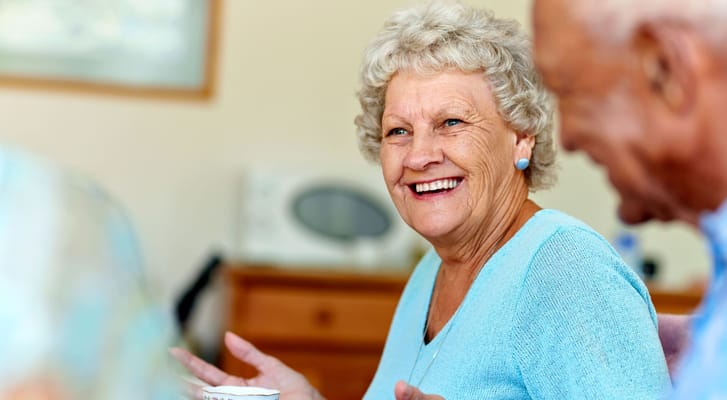 Resident smiling and interacting during an activity