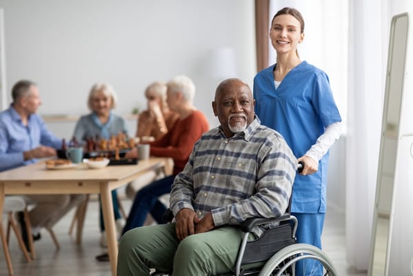Caregiver smiling with resident in a common area