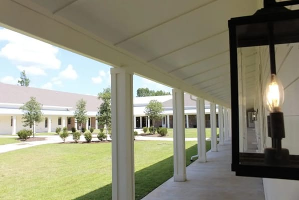 A walkway leading through a landscaped area of the facility