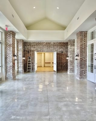 Bright common area with brick and polished floors