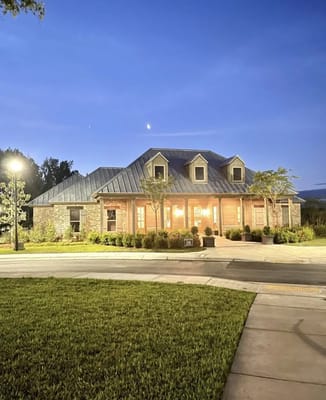Exterior view of Gardens of Somerset facility at dusk