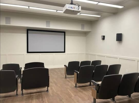 Interior of a small screening room with seating