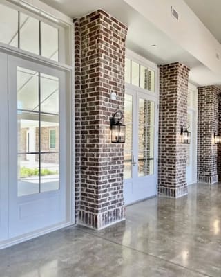 Bright corridor with brick pillars and large windows