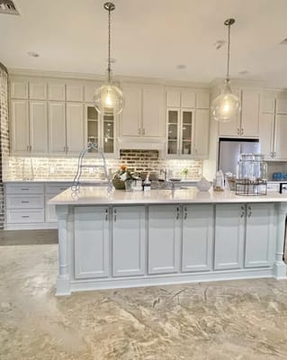 Modern kitchen interior with large island and pendant lights