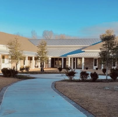 Exterior view of Gardens of Somerset with pathways and landscaping