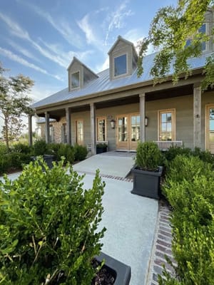 Building exterior with landscaped entrance and patio