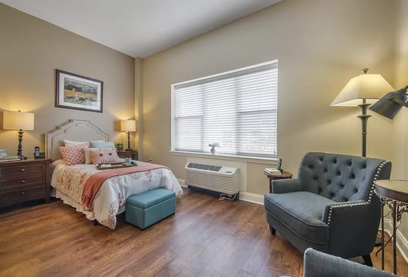 Cozy private resident room with a bed and seating