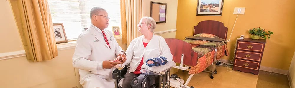Resident interacting with staff in a private room
