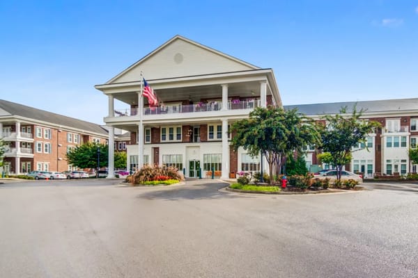 Exterior view of a senior living facility with landscaped entrance