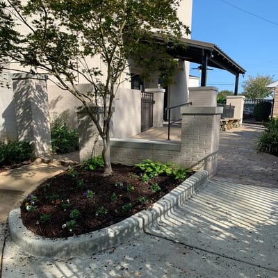 Outdoor entrance area with landscaped flower bed