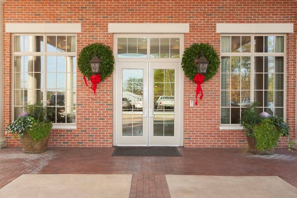 Entrance with holiday decorations and greenery